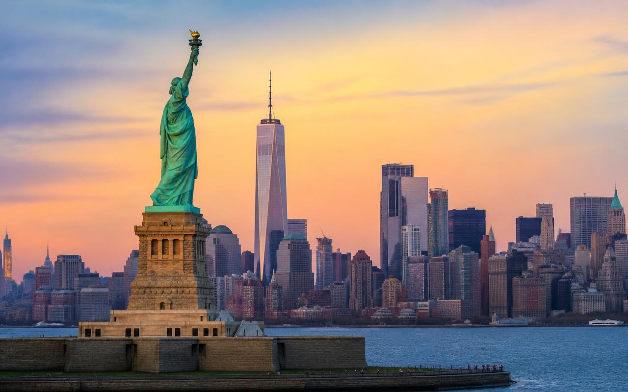 Statue of Liberty and the Manhattan skyline at sunset